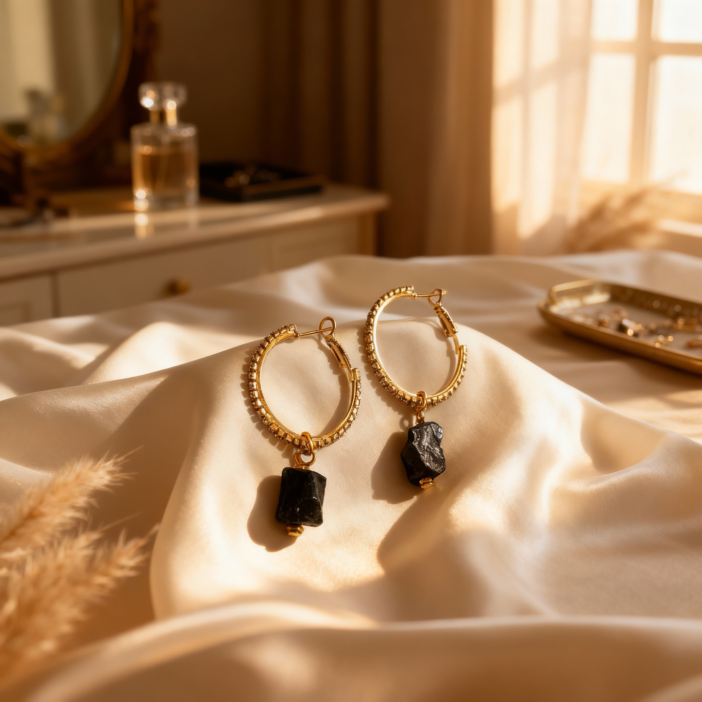 Elegant gemstone hoop earrings featuring black tourmaline and gold-plated accents.