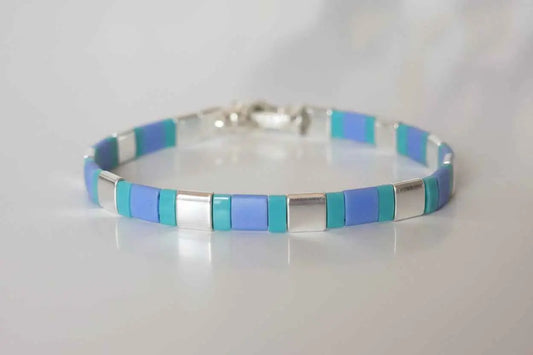 Azure Pulse Tila Bracelet by Gem N Glow features vibrant blue beads and intricate design for stylish wristwear.