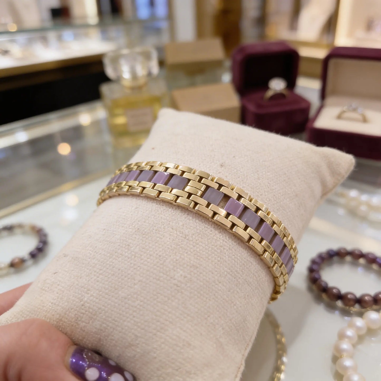 Handmade Soft Blush Miyuki Tila bracelet from the Ivory Rhythm Collection displayed on ivory jewelry pillow