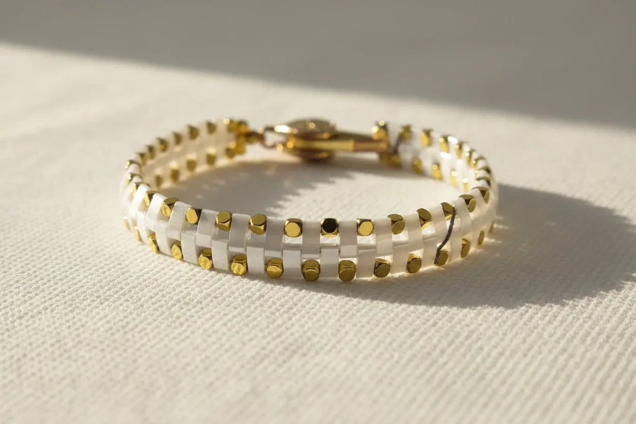 Handcrafted white and gold Miyuki bracelet with modern minimalist styling from the Metal Motion collection by Gem & Glow by Natali.